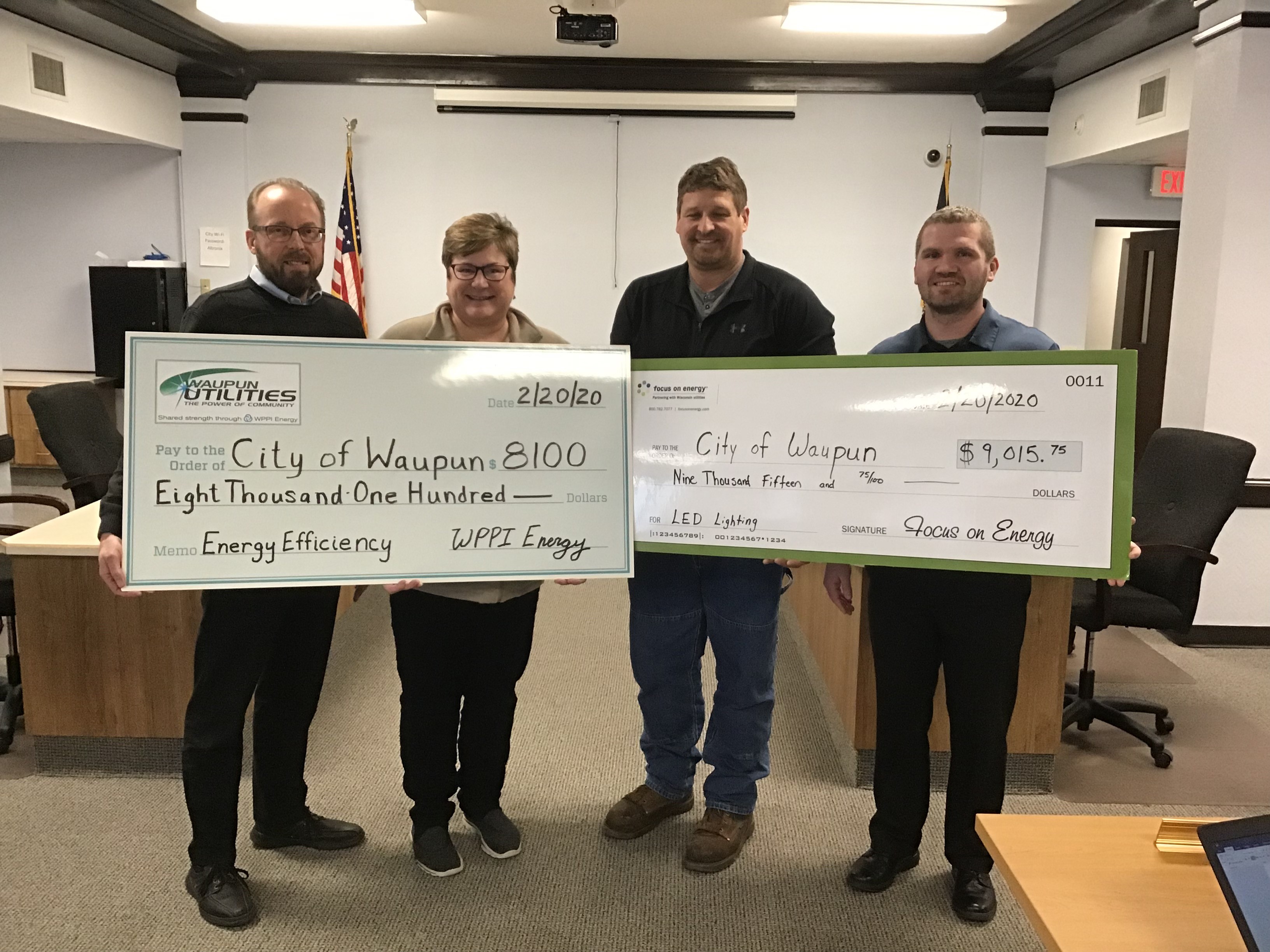 Waupun Mayor Julia Nickel and City Director of Public Works Jeff Daane accept financial incentive checks from Eric Kostecki with WPPI Energy and Joe Kottwitz of Focus on Energy